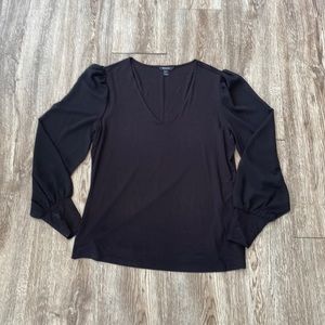 RW&Co black blouse with sheer lone sleeve arms.